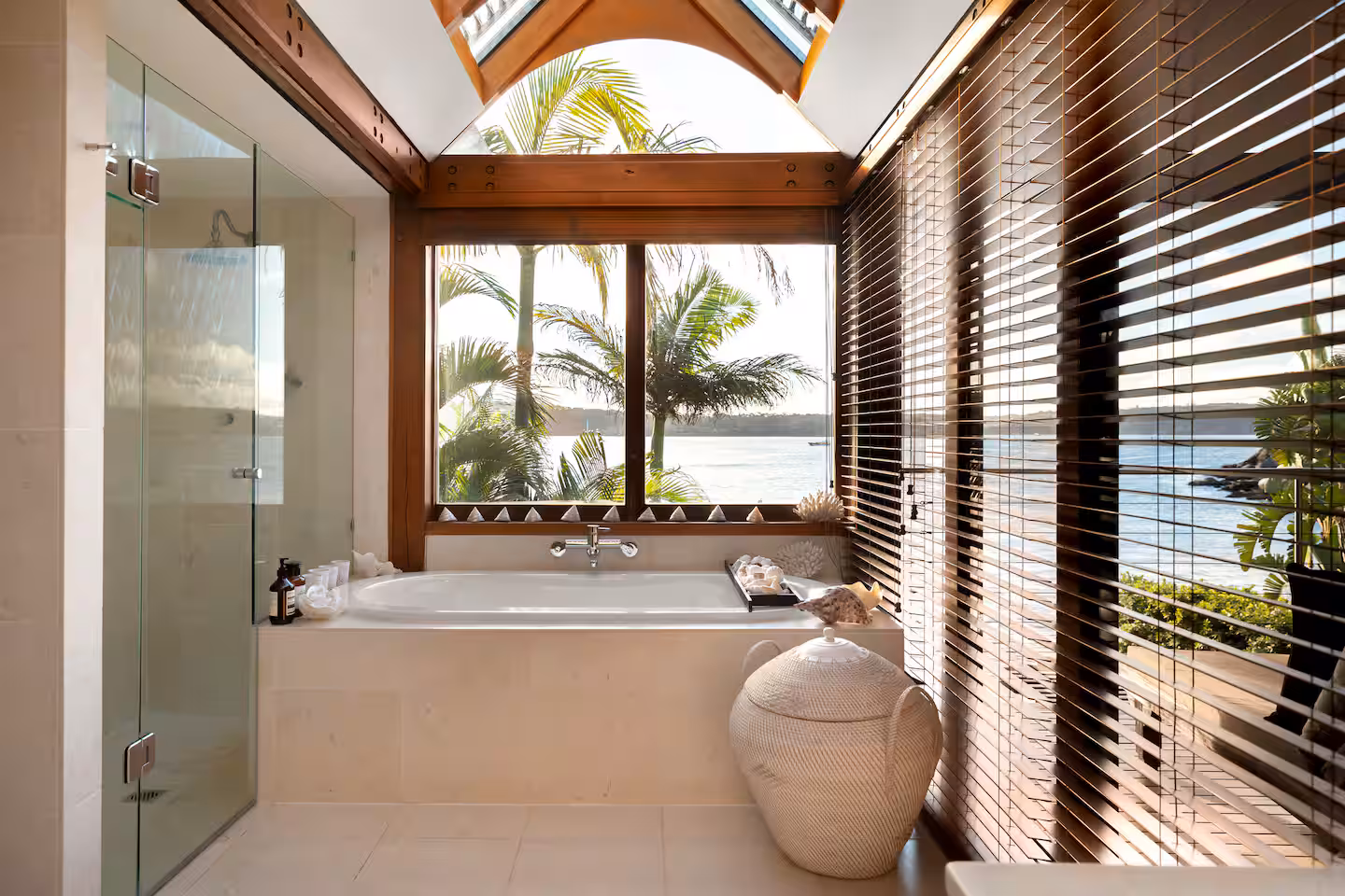 Private soaking bath in a calm stone-lined ensuite